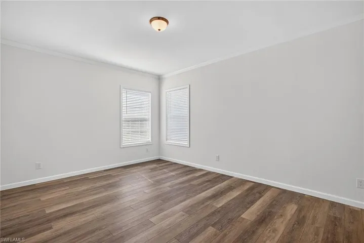 Primary Bedroom with LVP flooring and natural light