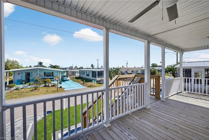 Deck featuring a residential view and a ceiling fan