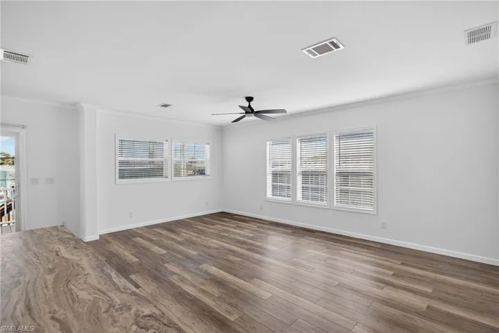 Living room with LVP flooring, healthy amount of natural light, and a ceiling fan