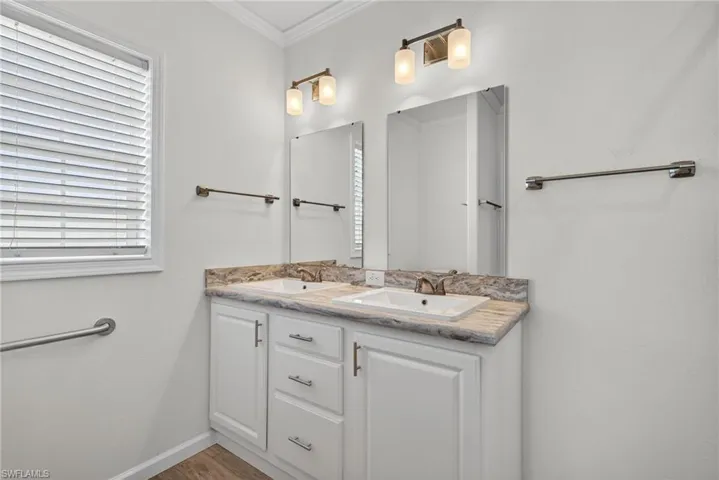 Bathroom with double vanity, and grab bar