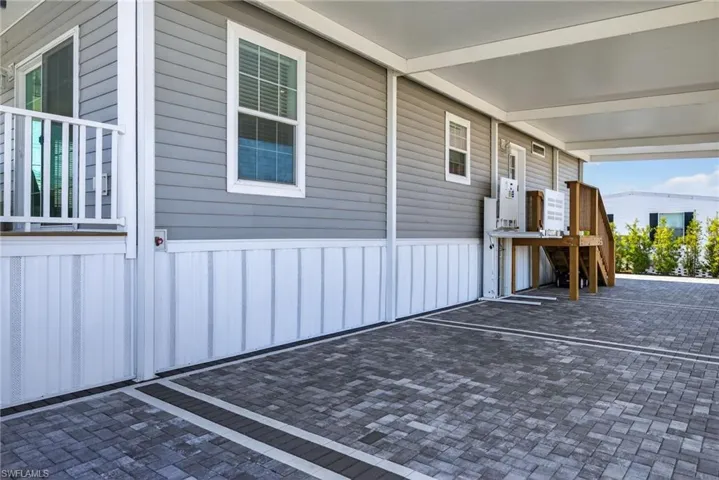 Wheelchair lift, paver driveway, carport and stairs