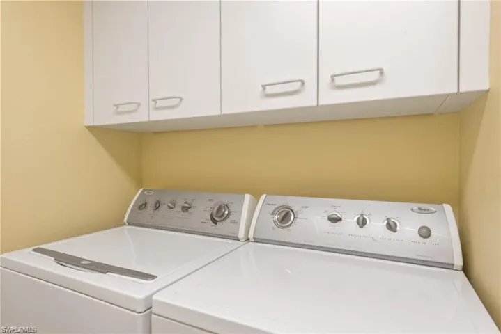 Spacious laundry room with East balcony access.
