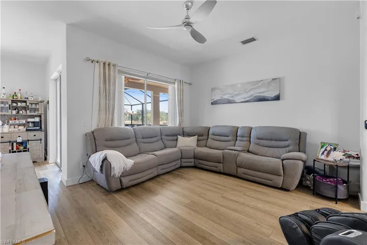 Living room with light wood-type flooring and ceiling fan