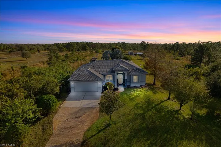 View of front of home featuring a lawn and a garage