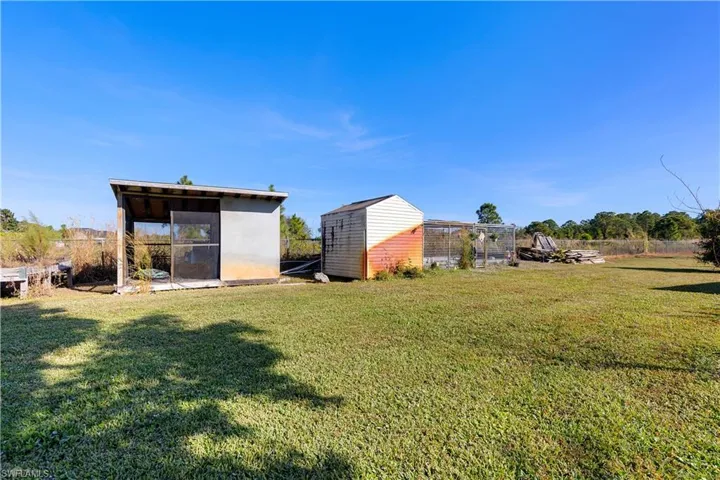 View of yard with a storage unit