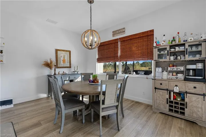 Dining room featuring a notable chandelier and light hardwood / wood-style flooring