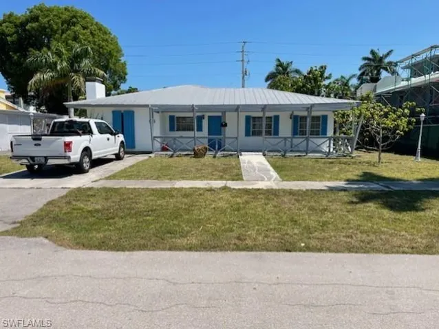 View of front of home featuring covered porch and a front yard
