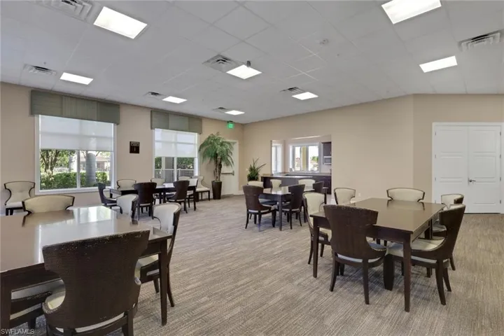 Dining space with a paneled ceiling and light carpet