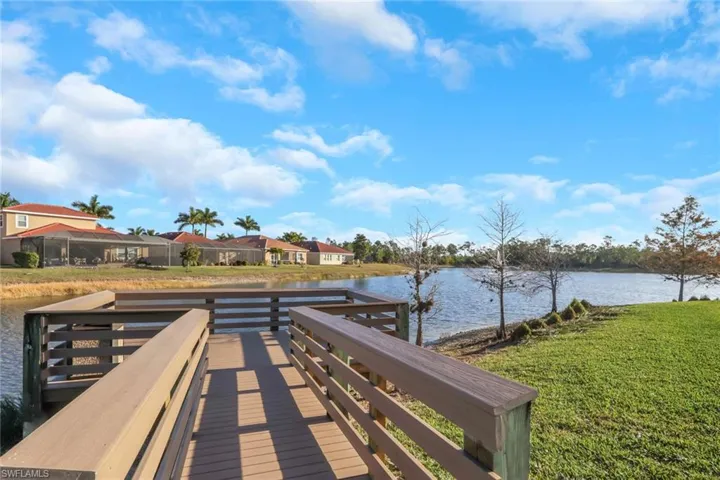 Dock with a lawn, a water view, and a residential view