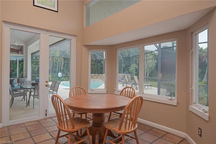 Kitchen eat-in area with views  of the water and French doors leading to the enclosed lanai/pool