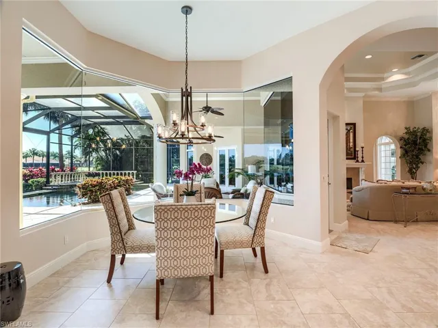 Casual dining area featuring an inviting chandelier, mitered glass windows with breath taking views