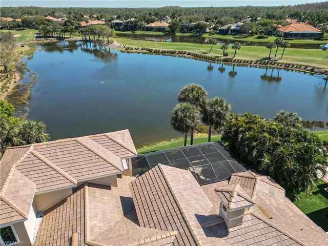Birds eye view of property with water and golf views