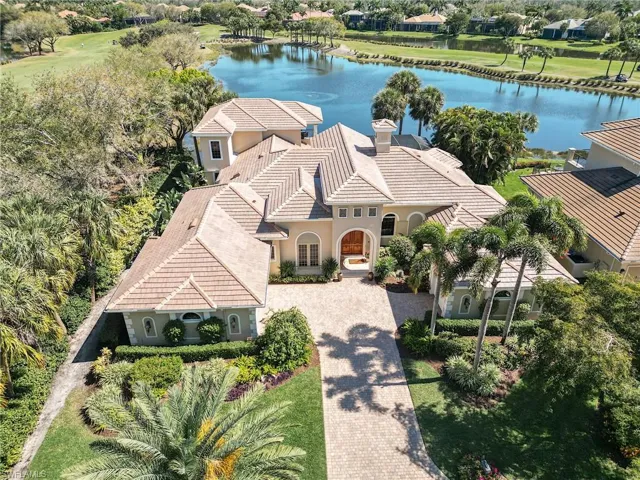 Aerial view featuring water and golf views
