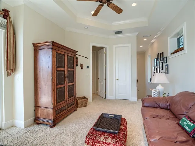 2nd floor leisure room (could be used as bedroom, office, gym) with tray ceiling with crown molding, ceiling fan, large closet and neutral colors