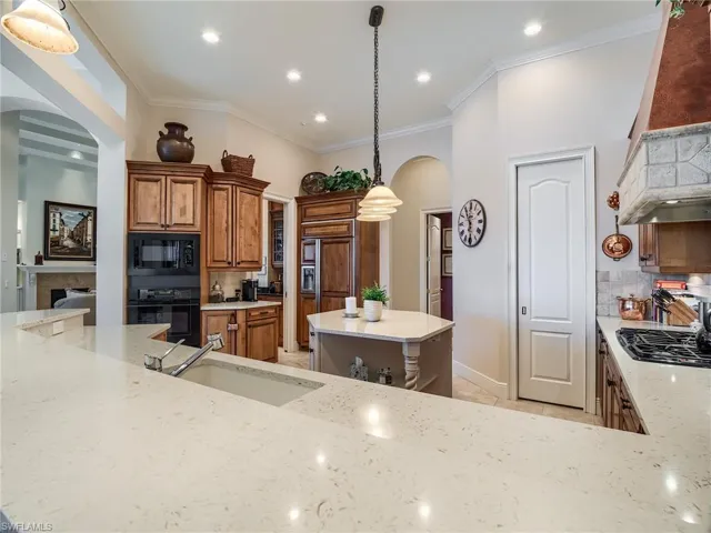 Kitchen featuring pendant lighting, a center island, and tasteful backsplash