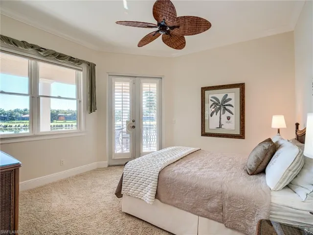 2nd floor guest bedroom with ceiling fan and access to exterior balcony