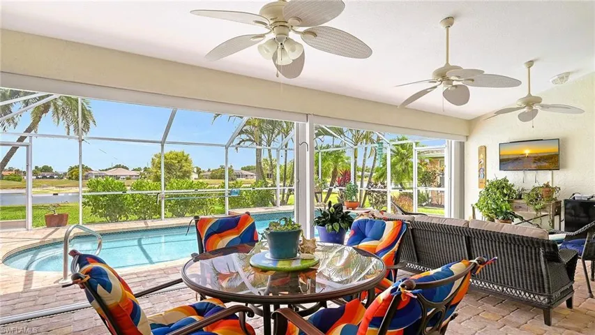 Sunroom / solarium with a ceiling fan and outdoor dining space