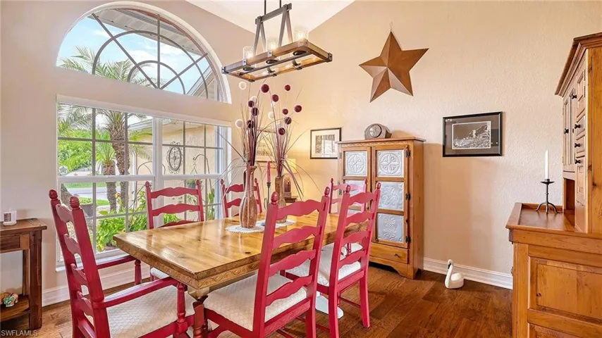 Dining space with wood finished floors, baseboards, and a chandelier