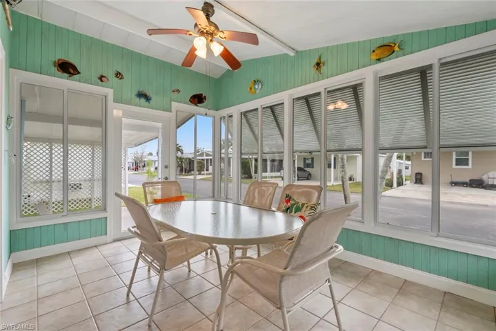 Sunroom / solarium featuring ceiling fan