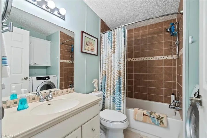 Full bathroom featuring washer / clothes dryer