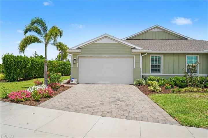 Exterior residence with light green siding and white trim