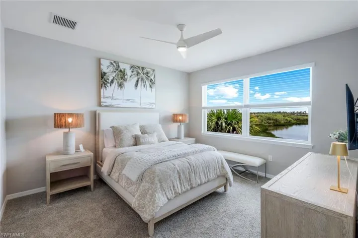 Carpeted bedroom with baseboards and a ceiling fan