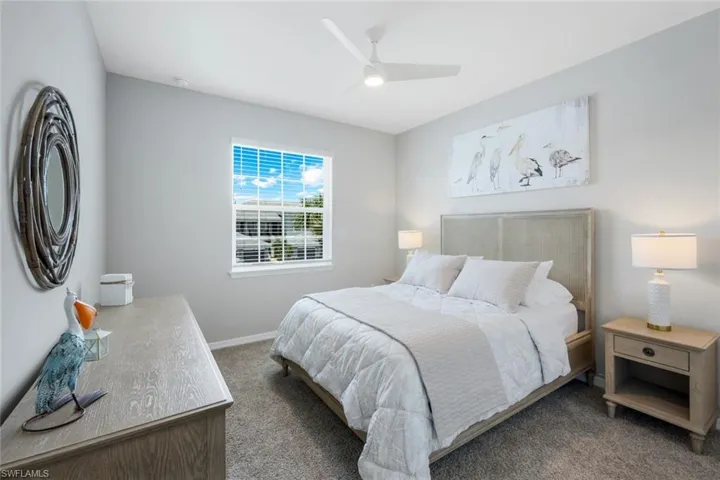 Carpeted bedroom with baseboards and ceiling fan