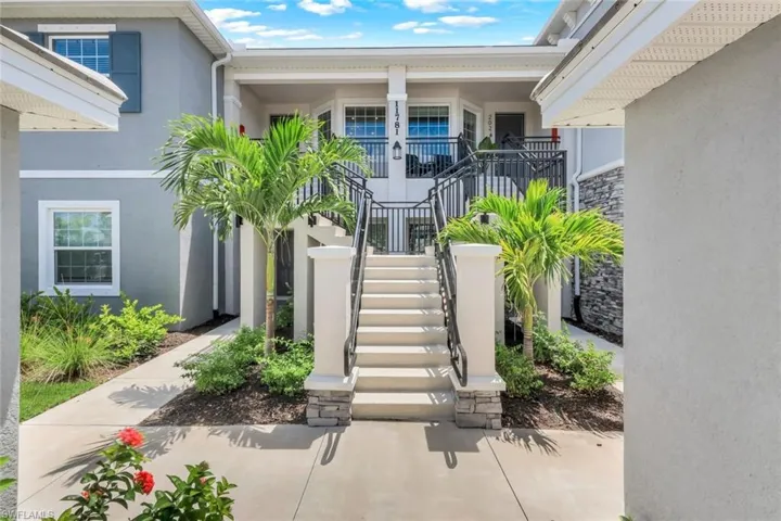 Doorway to property featuring stucco siding