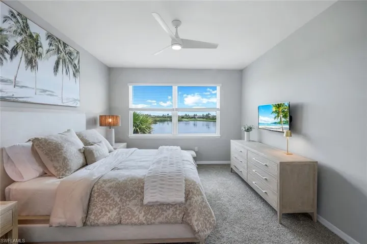 Bedroom featuring light colored carpet and a ceiling fan