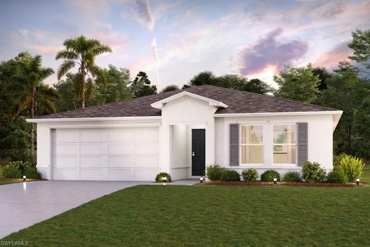 View of front of home featuring a garage and a yard