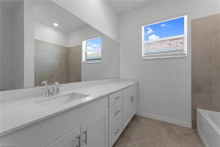 Bathroom with vanity and tile patterned flooring