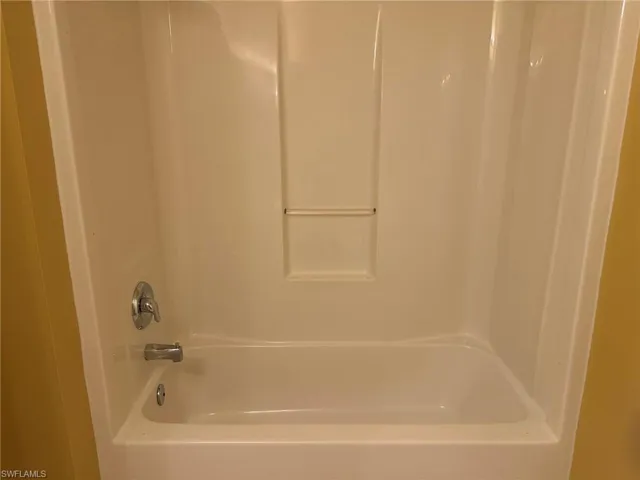 Full bathroom with shower / bathtub combination