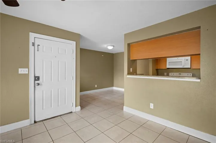 Entrance foyer featuring baseboards and light tile patterned floors