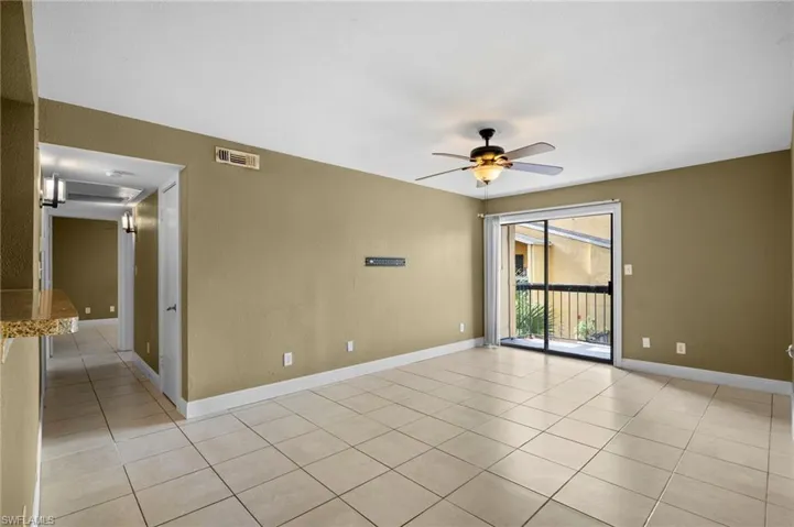 Spare room featuring a ceiling fan and light tile patterned floors