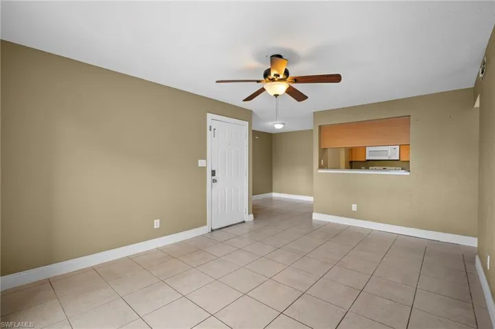 Spare room featuring light tile patterned floors and a ceiling fan