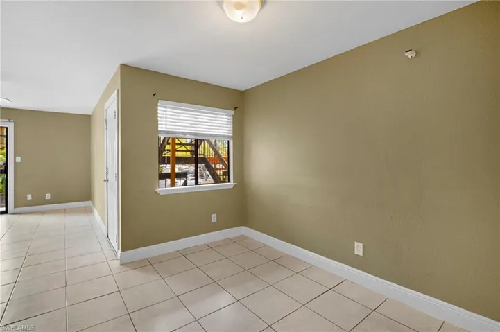 Spare room with baseboards and light tile patterned flooring