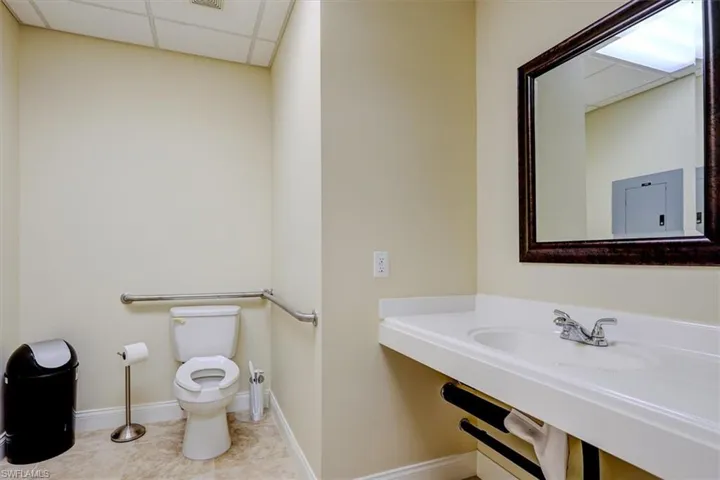 Bathroom with a paneled ceiling and light tile patterned flooring