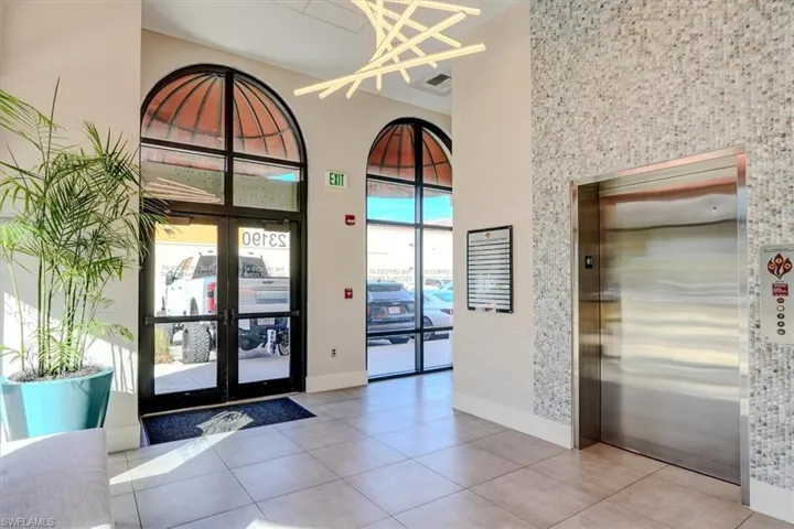 South Entrance lobby to elevator & mailboxes with a high ceiling