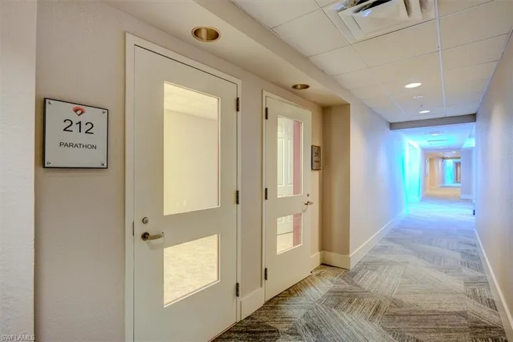 Common area Hallway featuring commercial light carpet, a drop ceiling, and recessed lighting