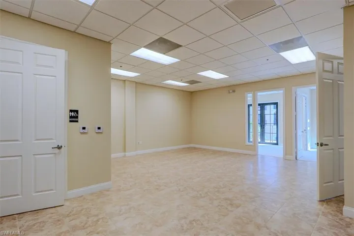 Extra large tiled open area leading to offices & balconies.  Rest room on the front left side