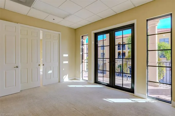 Doorway to outside with a paneled ceiling and carpet floors