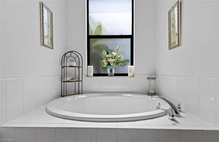 Bathroom with tiled bath and plenty of natural light
