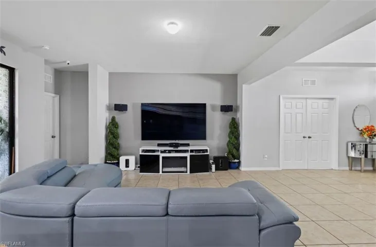 Living room featuring light tile floors