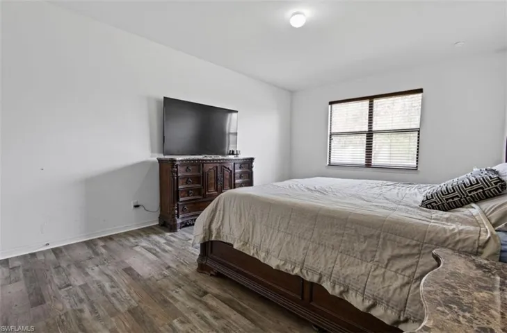 Bedroom featuring dark wood-type flooring