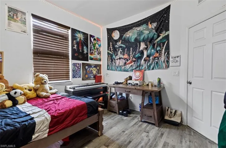 Bedroom with hardwood / wood-style floors