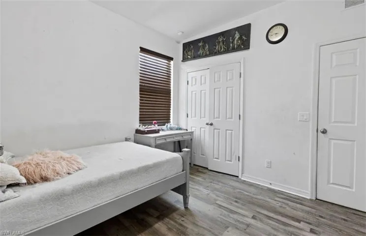 Bedroom with hardwood / wood-style floors