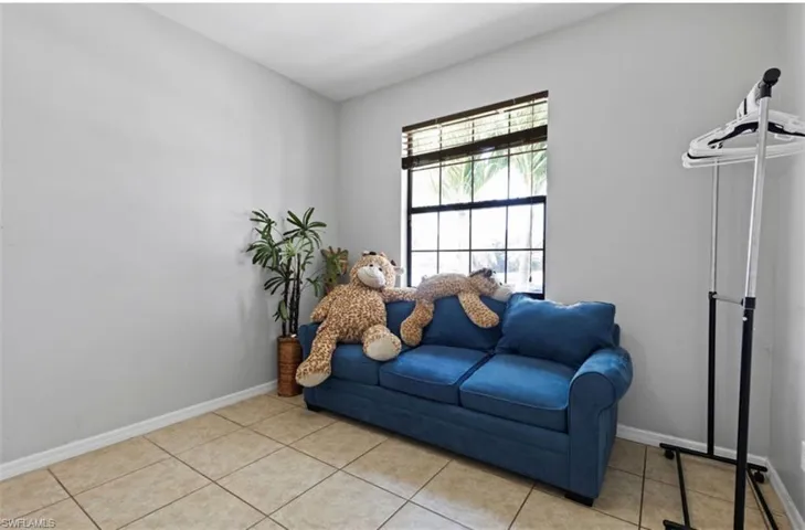 Living area featuring light tile floors