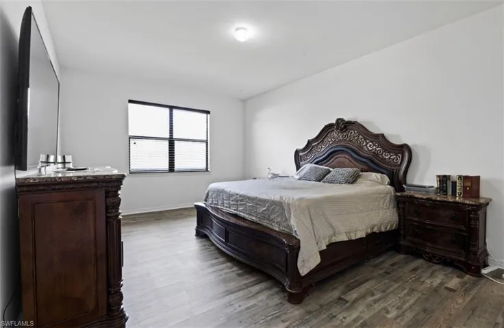 Bedroom with dark wood-type flooring
