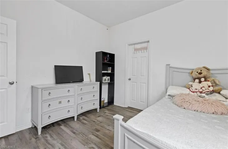 Bedroom with hardwood / wood-style flooring