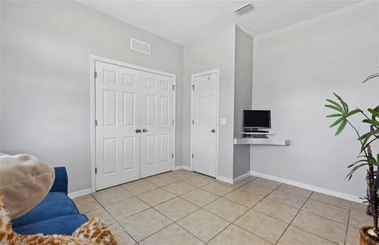 Living area featuring light tile floors